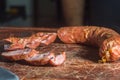 Sliced Ã¢â¬â¹Ã¢â¬â¹smoked calabrese sausage in a wooden table,copy space